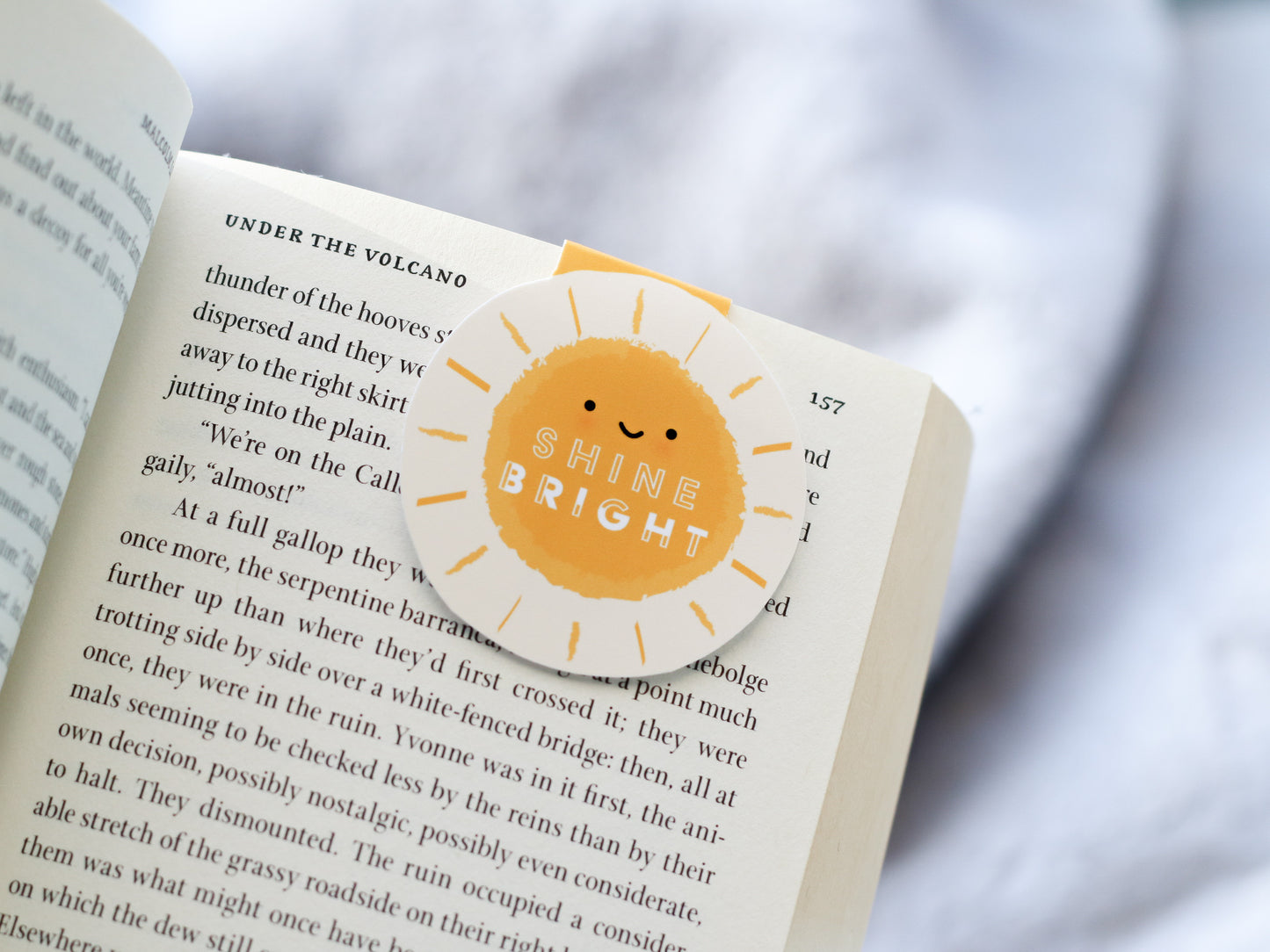 Shine Bright Sunshine Magnetic Bookmark by Craftedvan, inside a book.